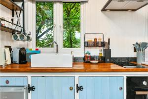 a kitchen counter with a sink and a window at Stag Shepherds Hut in Hartfield
