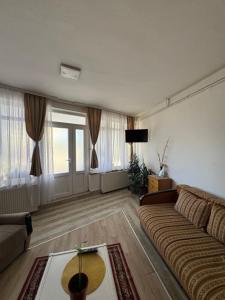a living room with a couch and a table at Smart stay in Leskovac