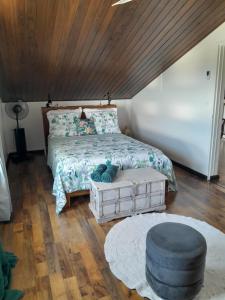 a bedroom with a bed with a wooden ceiling at L'Empreinte by LONBRAZ VOLKAN in Saint-Philippe