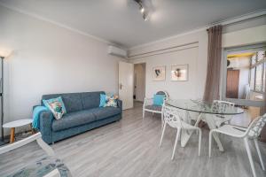 a living room with a couch and a table at Beach Apartment On The Beach in Praia da Rocha