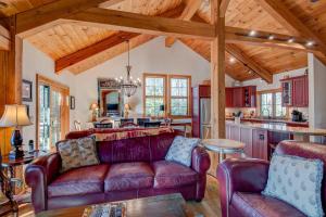 a living room with a couch and a kitchen at Muir Lodge in Blowing Rock +33 photos