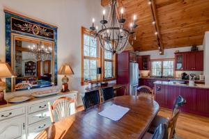 a kitchen with a wooden table and a dining room at Muir Lodge in Blowing Rock