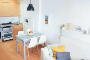 a kitchen and living room with a table and a couch at Blanca Mar in Barrio-Mar