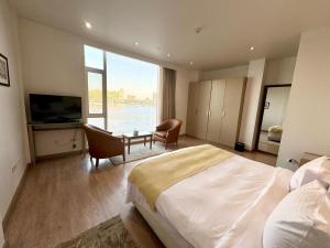 a hotel room with a large bed and a television at Riverside Hotel in Cairo