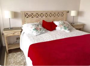 a bedroom with a large bed with two night stands at Departamento en Pingueral, Vista Maravillosa in Dichato +2 photos