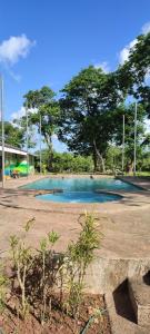 a swimming pool in a park with trees in the background at Eco Greene Farm in Puerto Princesa City