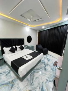a bedroom with a large bed with a large carpet at Hotel Golden Park in Ahmedabad