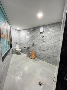 a bathroom with a toilet and a mirror at Hotel Golden Park in Ahmedabad +13 photos
