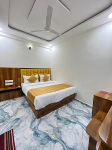 a bedroom with a bed on a large carpet at Hotel Golden Park in Ahmedabad