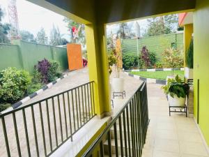 a balcony with two benches and a fence at Glory Motel by HODAC LTD in Kigali +4 photos