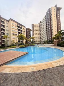 a large swimming pool in front of some buildings at Louisse 223 Avida in Molo