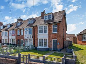 a house with a fence in front of it at 3 Bed in Mundesley 75160 in Mundesley