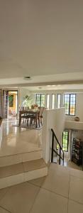 a large living room with a table and chairs at Atelier Fleur in Diego Martin