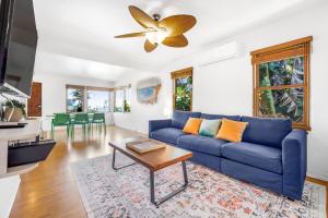 a living room with a blue couch and a table at 2BR-2 mins to Ocean-Sleeps 8-Pets in San Diego