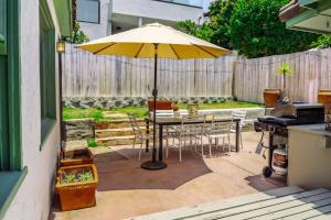 a table with a yellow umbrella on a patio at 2BR-2 mins to Ocean-Sleeps 8-Pets in San Diego +68 photos