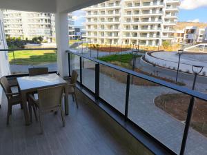a balcony with a table and chairs and a building at Caesar Blue Resort & Spa apartment D10 in Kalecik