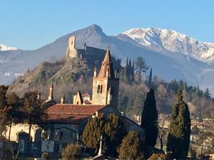 an old church with a mountain in the background at la casa di Shanti in Avigliana