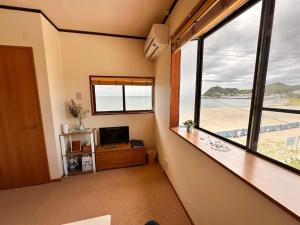a room with a large window and a television at kupono - Vacation STAY 00641v in Minamiboso