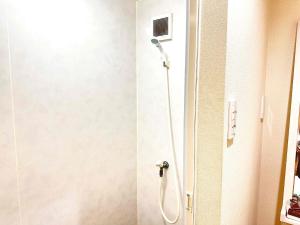 a shower in a bathroom with a shower head at kupono - Vacation STAY 00641v in Minamiboso