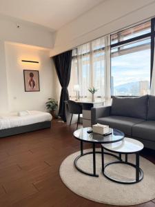 a living room with a couch and a table at Luxhouz Suites at Times Square Kuala Lumpur in Kuala Lumpur +52 photos
