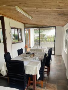 a dining room with a large table and chairs at Crown Eagle Guest House in Harding