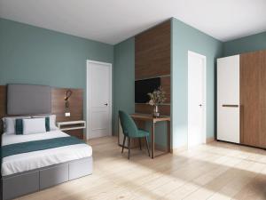 a bedroom with a bed and a desk with a television at Hotel Livata Mountain & Wellness in Subiaco