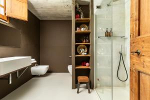 a bathroom with a shower and a toilet and a sink at Palazzo 54 in Germagnano
