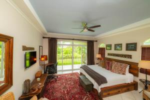 a bedroom with a bed and a large window at Colina 8E 2 bdr Garden View in Los Suenos in Isla Herradura +38 photos
