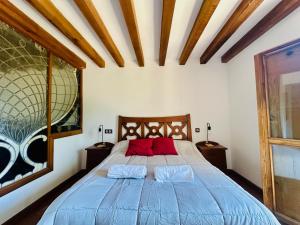 a bedroom with a blue bed with two pillows at La Mansion de Gallegos in Gallegos