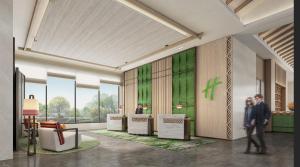 een weergave van een lobby met mensen in een gebouw bij Holiday Inn Pu'er Jingmai by IHG in Mengman