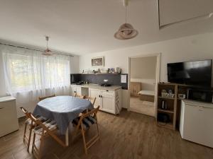 a kitchen and dining room with a table and chairs at Chill & Pool Retreat Almádi in Balatonalmádi