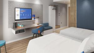 a hotel room with two beds and a flat screen tv at Holiday Inn Express Kunming Yiliang Center by IHG in Kunming