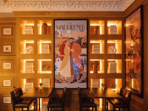 a dining room with two tables and a movie poster at Only YOU Boutique Hotel Madrid in Madrid