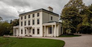 a large white house with a lawn in front of it at South Devon - River Dart Views - Free Parking - Pet Friendly in Galmpton-on-the-Dart