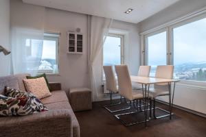 a living room with a couch and a table and chairs at Tott vacation homes in Åre