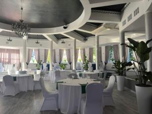 a banquet hall with white tables and white chairs at Szafir in Rzeszów
