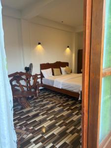 a bedroom with a bed and a chair at Mango tree ella in Ella