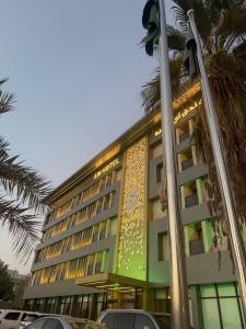 a building with a sign on the side of it at AW Hotel Riyadh in Riyadh