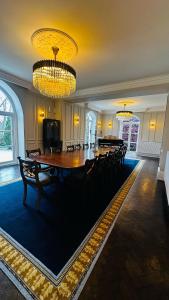 a large dining room with a large table and chairs at Moorswater Lodge in Liskeard