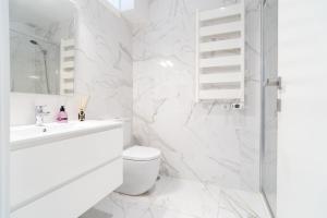 a white bathroom with a toilet and a shower at Vegan Pátio - Douro e Ribeira in Bandeira +35 photos