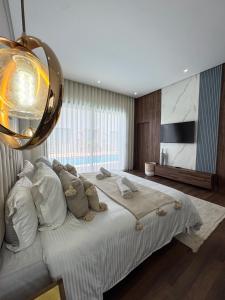 a bedroom with a large bed and a large window at Villa Ramona in Marrakech