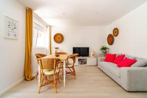 a living room with a table and a couch at Vegan Pátio - Douro e Ribeira in Bandeira
