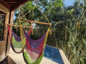 a couple of hammocks hanging from a porch at Runaway Pineapple Lodge in Mangrove Bight