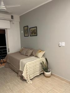 a bedroom with a bed with a blanket on it at cerca de costa y centro con cochera in Corrientes