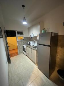 a kitchen with a refrigerator and a counter top at cerca de costa y centro con cochera in Corrientes