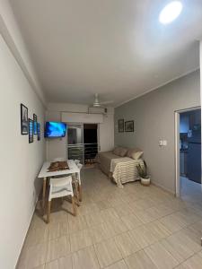a bedroom with a bed and a table in a room at cerca de costa y centro con cochera in Corrientes