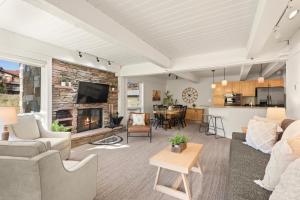 a living room with a couch and a fireplace at Enclave 209, Snowmass Ski-In/Ski-Out Condo w/Shared Pool/Hot Tub in Snowmass Village