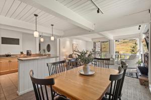 a dining room and kitchen with a table and chairs at Enclave 209, Snowmass Ski-In/Ski-Out Condo w/Shared Pool/Hot Tub in Snowmass Village