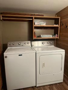 a kitchen with a stove and a washer at Cozy Lake Cabin in Eagle Rock
