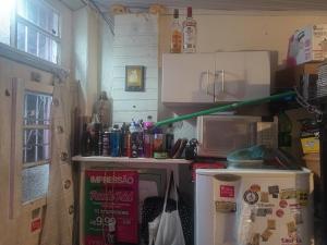 a kitchen with a refrigerator and a microwave at Cytau Office Wi-fi 3 Estações Trabalho 1 Dormitório Cozinha Sofá in Porto Alegre +3 photos